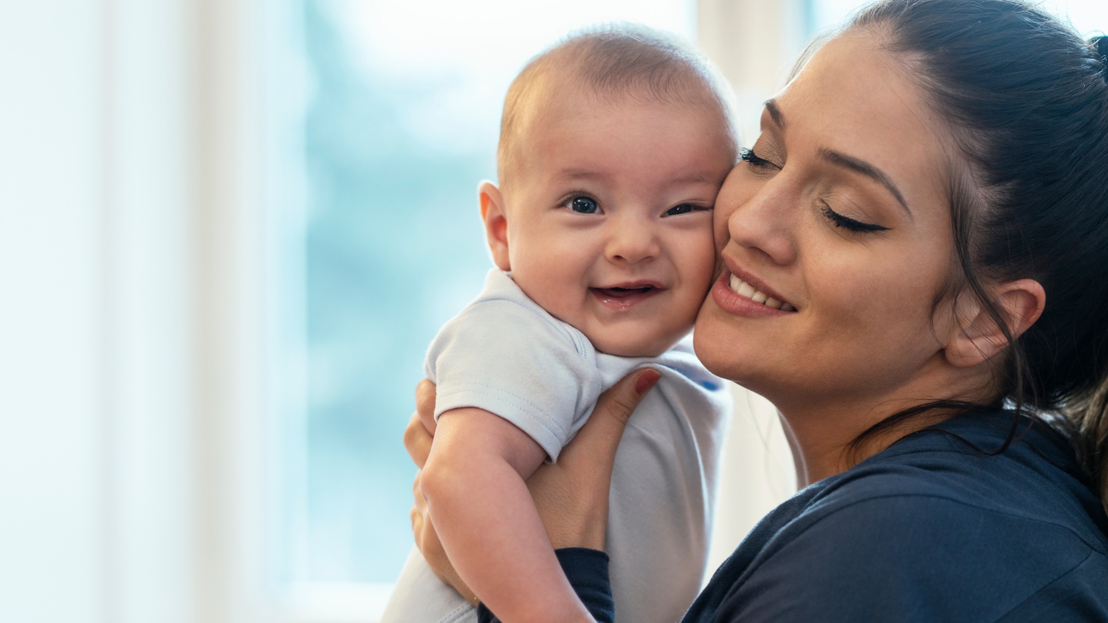 baby and mother cheek to cheek